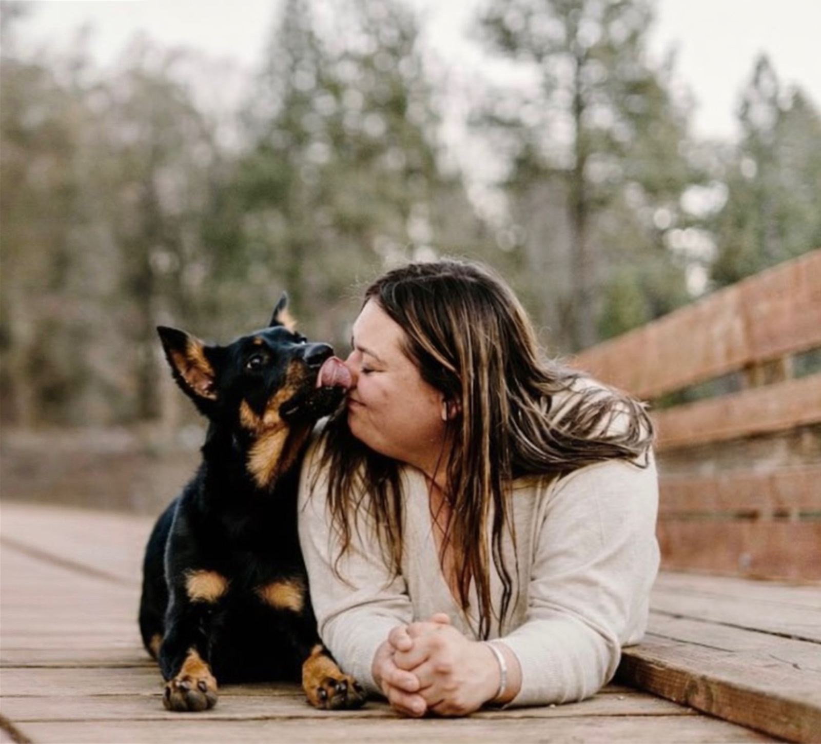 Bri sharing a kiss with Lemon on a wooden deck